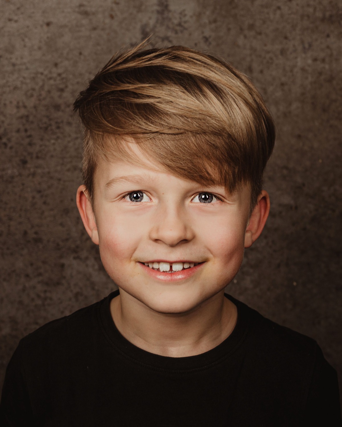 A happy young client after their haircut at Servanté Studio